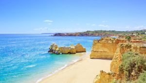 Beach and rock formation known as Praia da Rocha in travel destination Portimao. Algarve, Portugal, Europe.